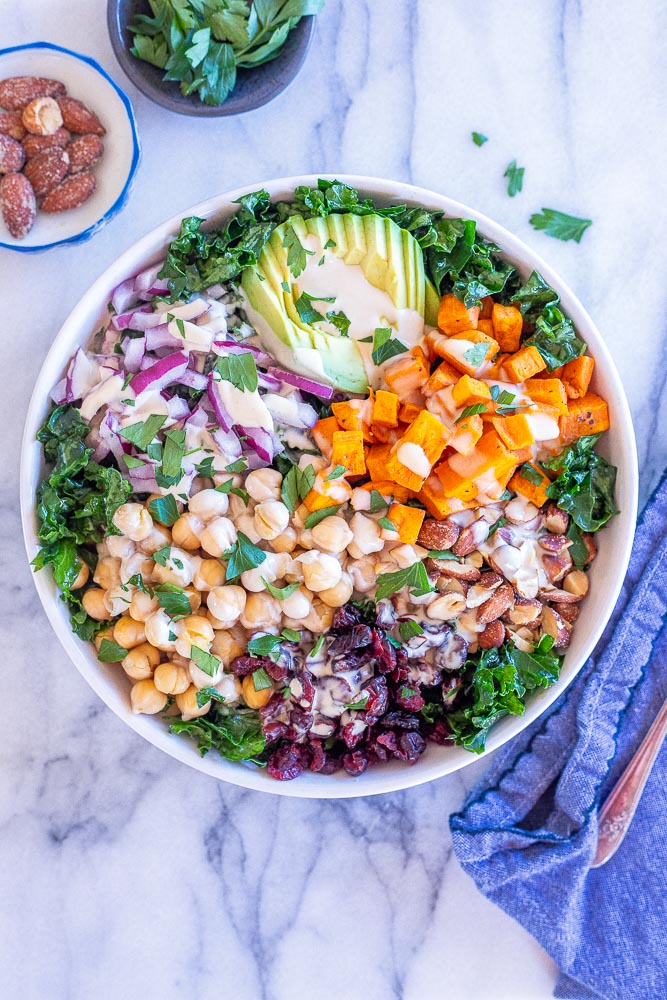 chopped kale power salad in a bowl with lemon tahini dressing