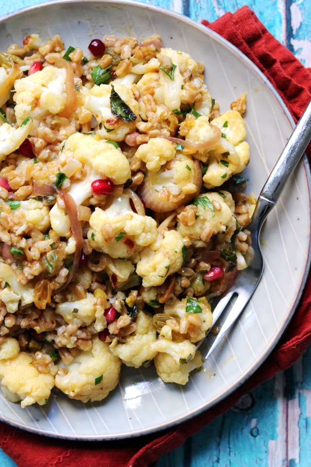 A plate full of food, with Salad and Cauliflower