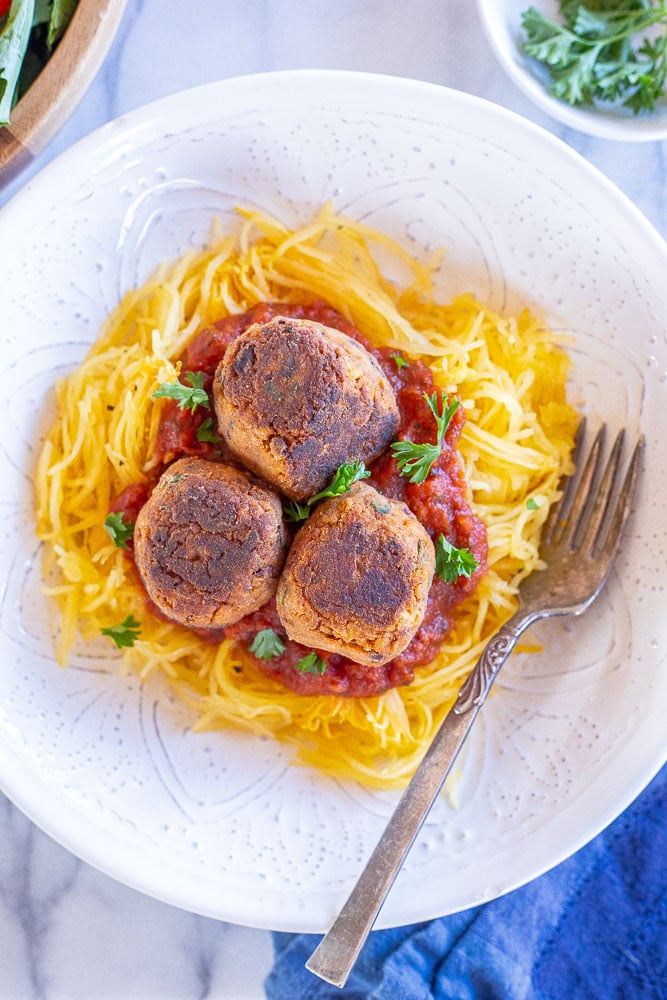 A bowl of spaghetti squash with vegan meatballs on top