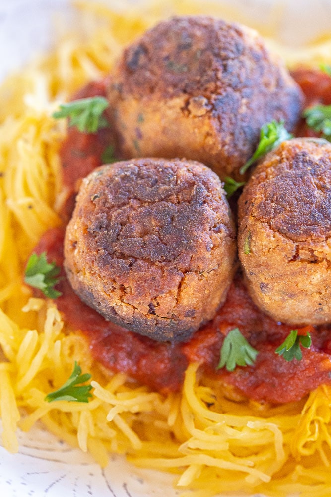 Close up of veggie meatballs on top of spaghetti squash
