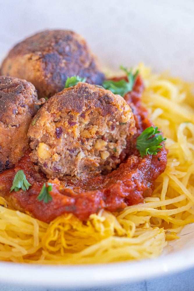 Vegan meatball with a bite taken out of it