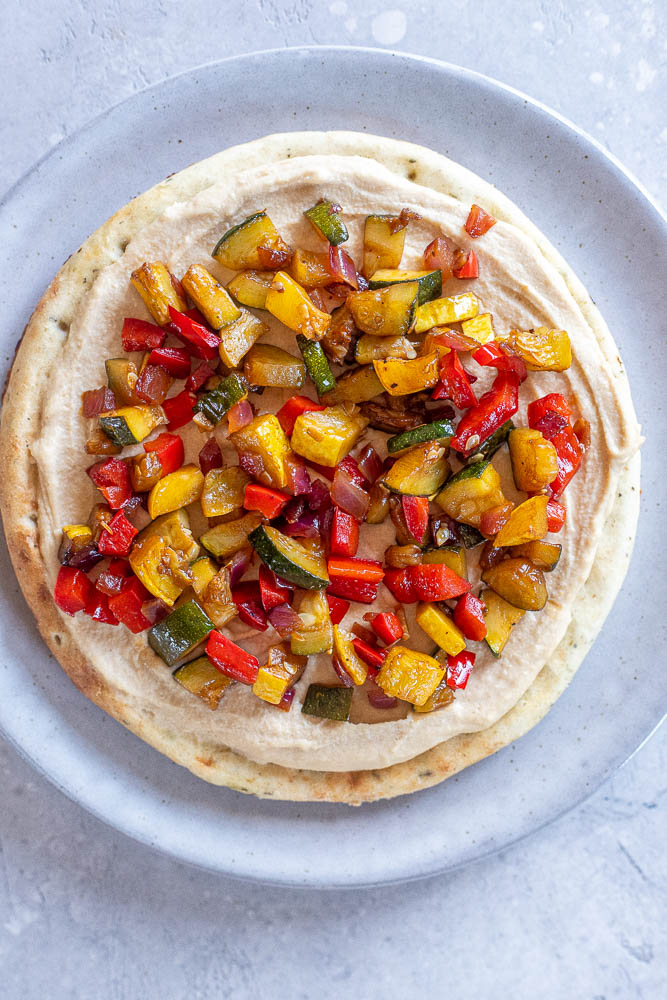 showing how to make a hummus flatbread recipe