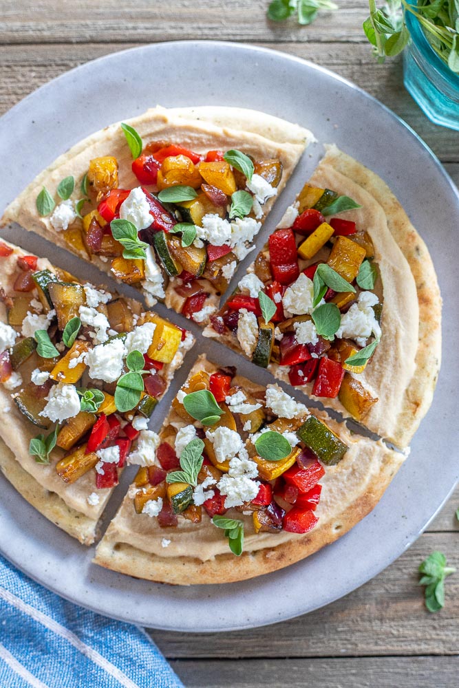 Hummus flatbread with balsamic vegetables on a plate