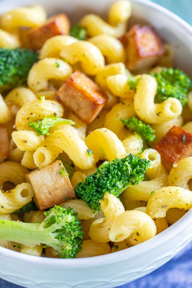 close up of a bowl of tofu broccoli pasta