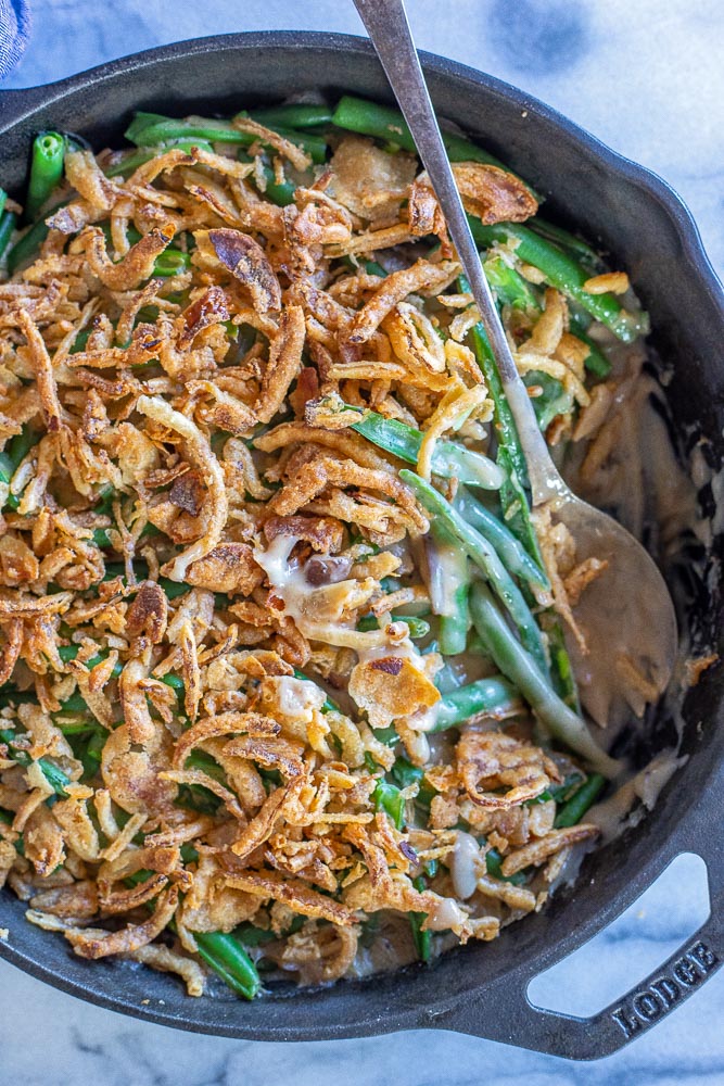 pan of green bean casserole with a spoon in it