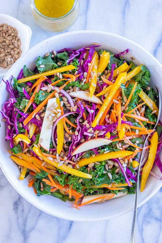 Sunshine Kale Salad all mixed together in a bowl