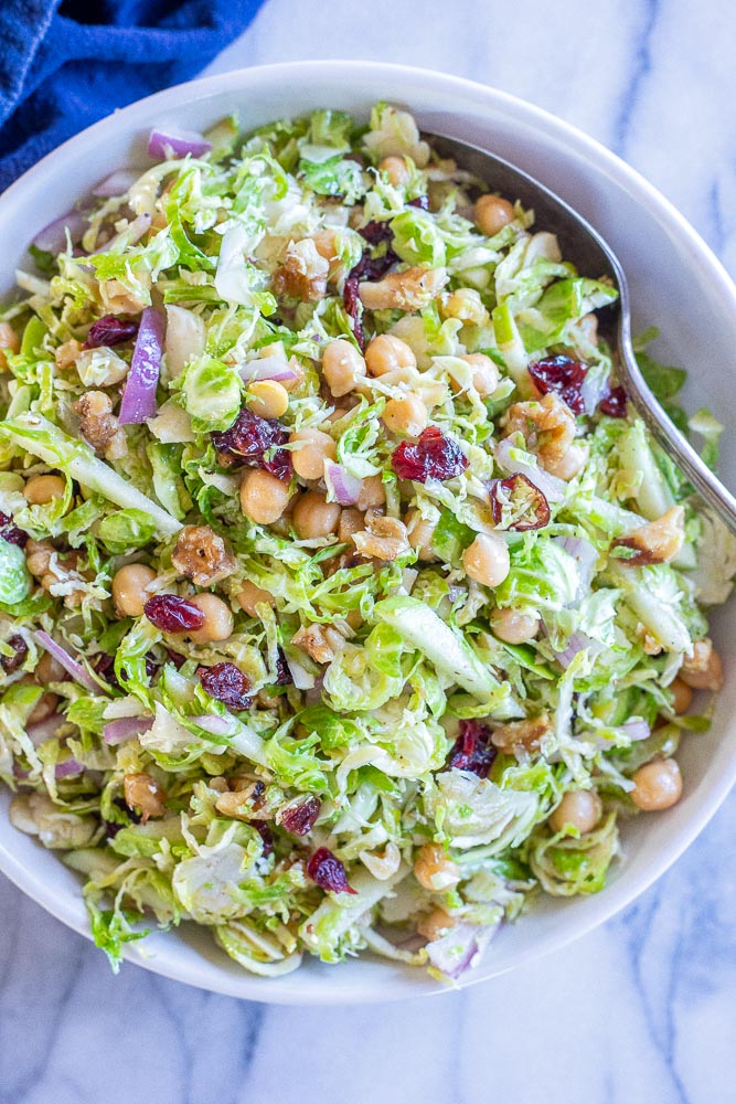 close up of a bowl of shaved Brussels sprout salad