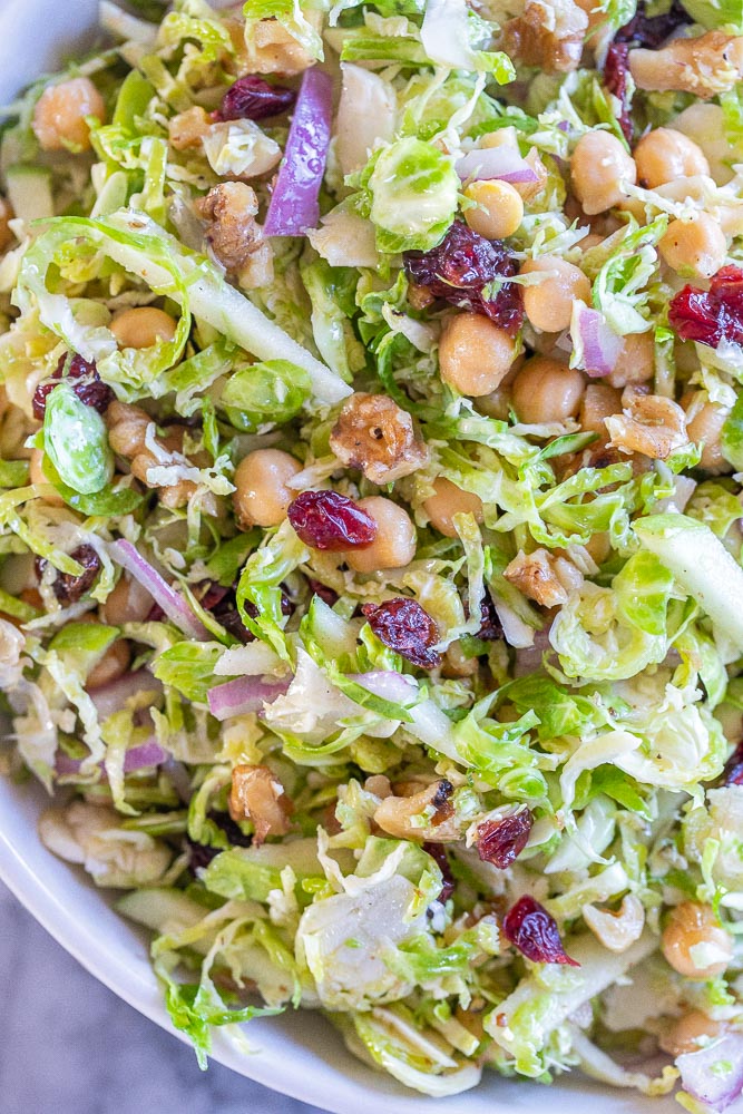 close up of a shaved Brussels sprout salad in a bowl