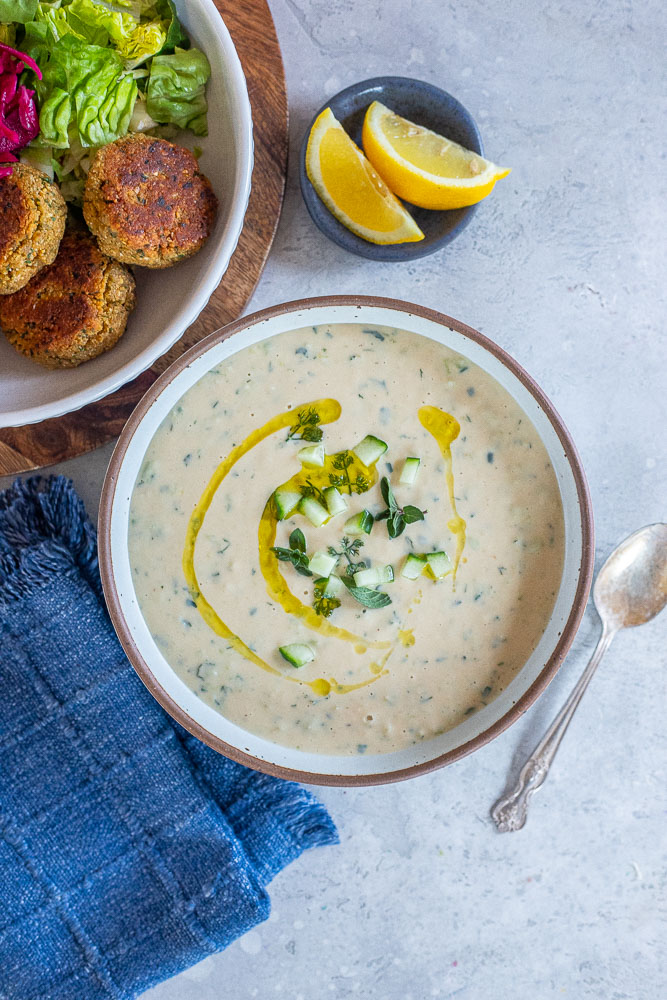 Vegan tzatziki sauce in a bowl with falafel and salad