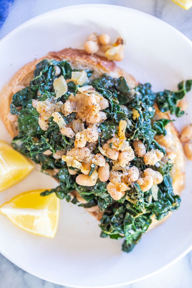 close up of garlicky kale with lemon on toast