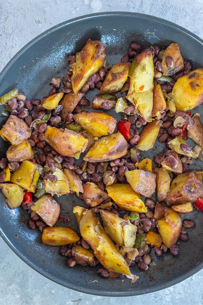 cooked potatoes with peppers and onions and black beans