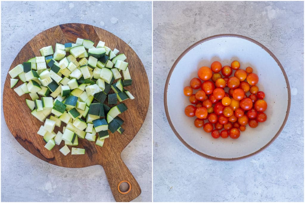 chopped zucchini on a cutting board and cherry tomatoes in a bowl