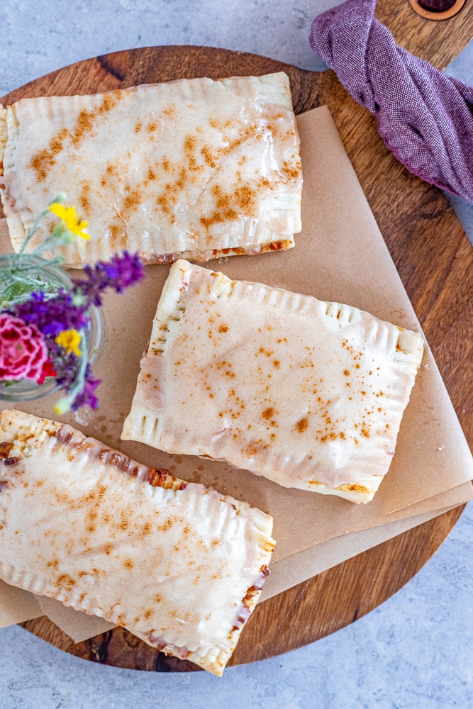 a cutting board with three Cinnamon Sugar Pop-Tarts on it