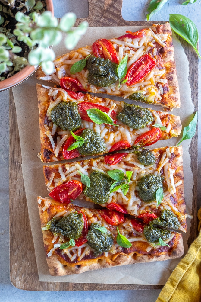 vegan pizza sliced on a cutting board