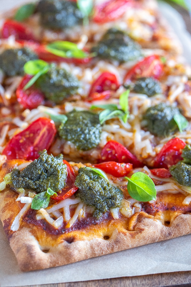 close up of vegan tomato pesto pizza