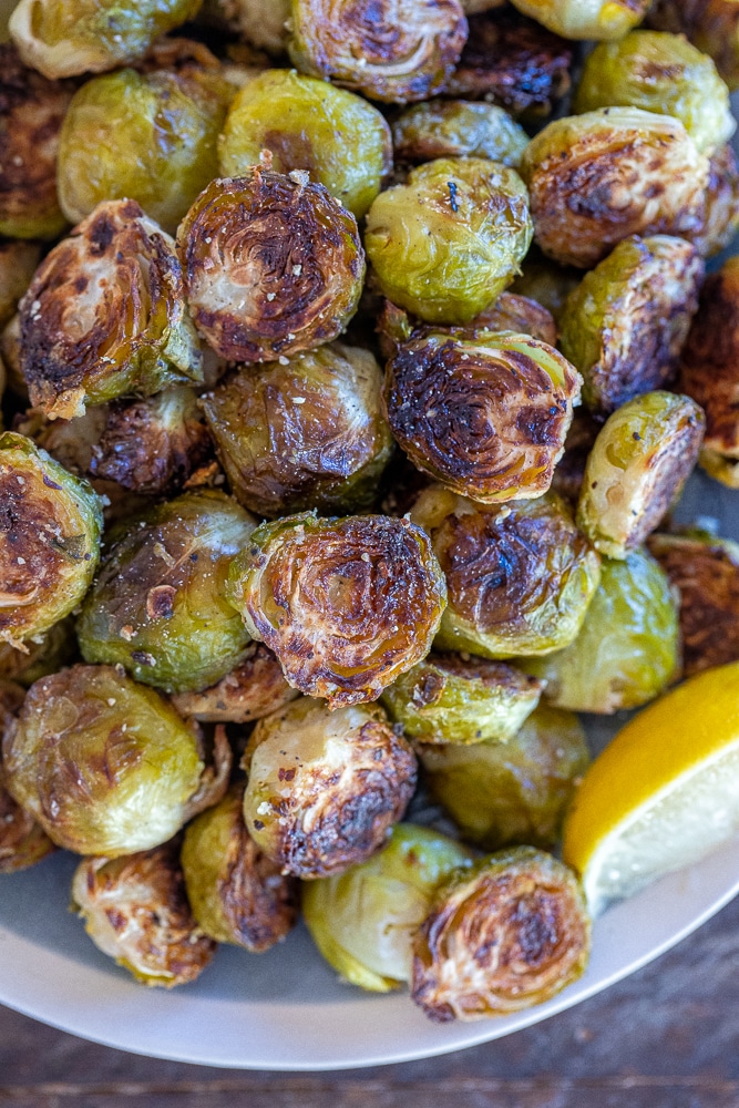 Roasted Brussels sprouts that are caramelized with lemon pepper