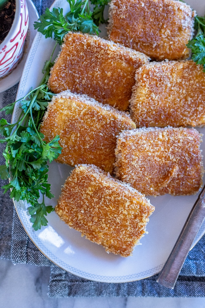 a platter of crispy fried tofu steaks with parsley