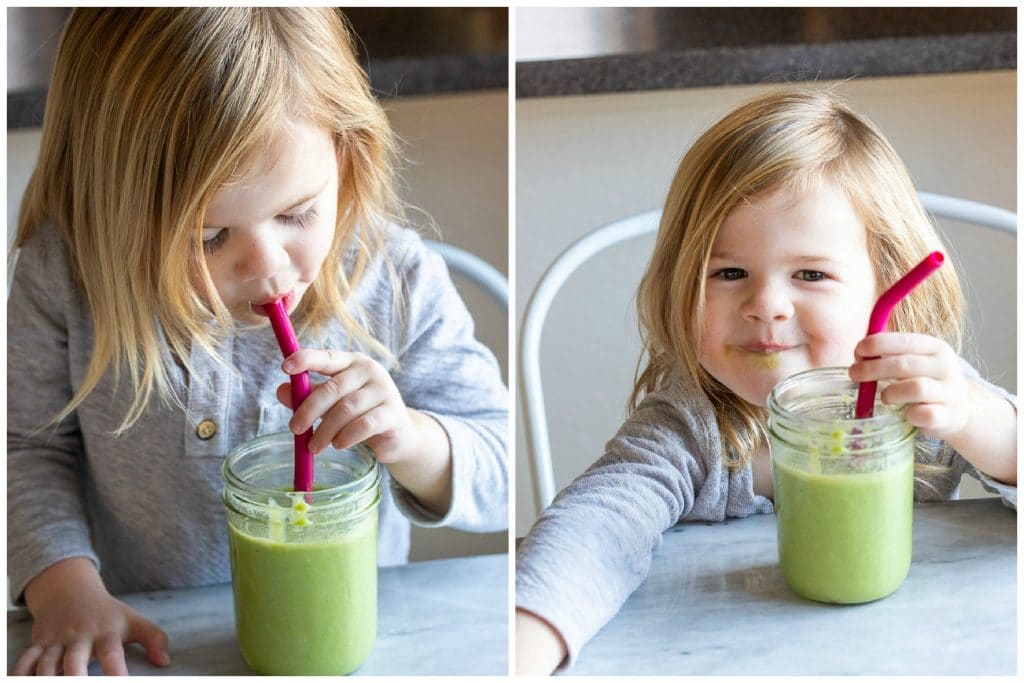 a child drinking a kid friendly green smoothie