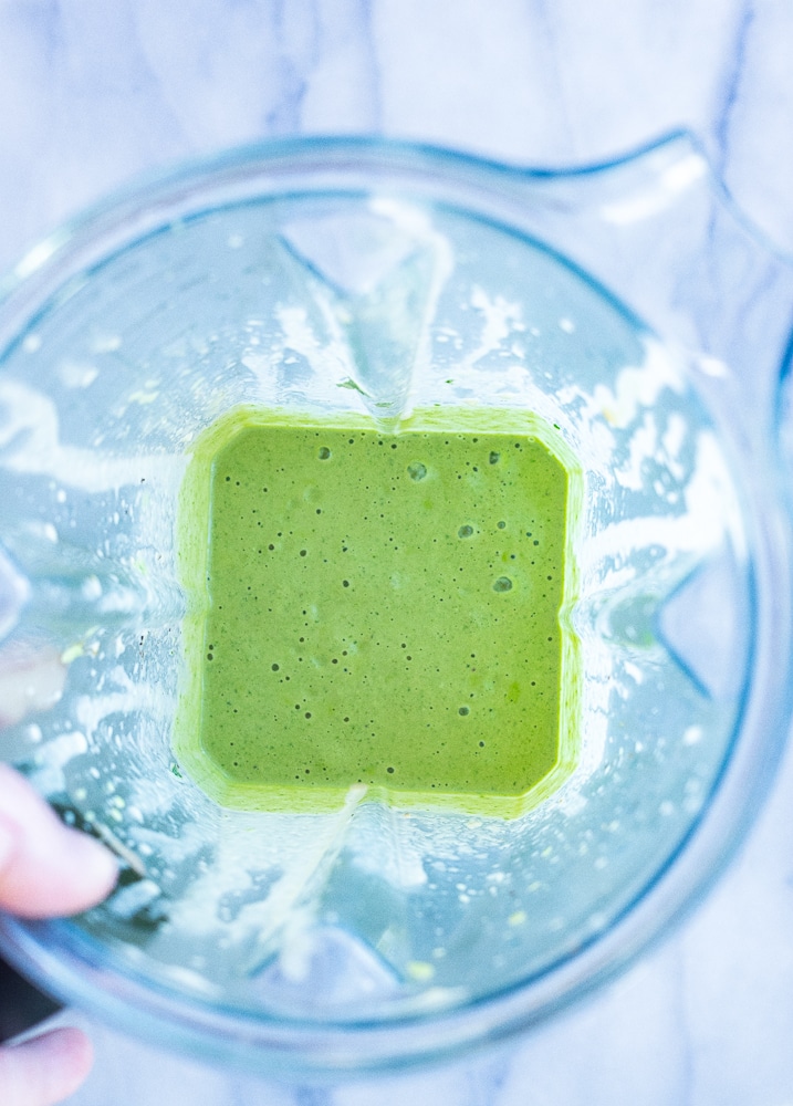 green tahini sauce blended up in the blender into a creamy sauce