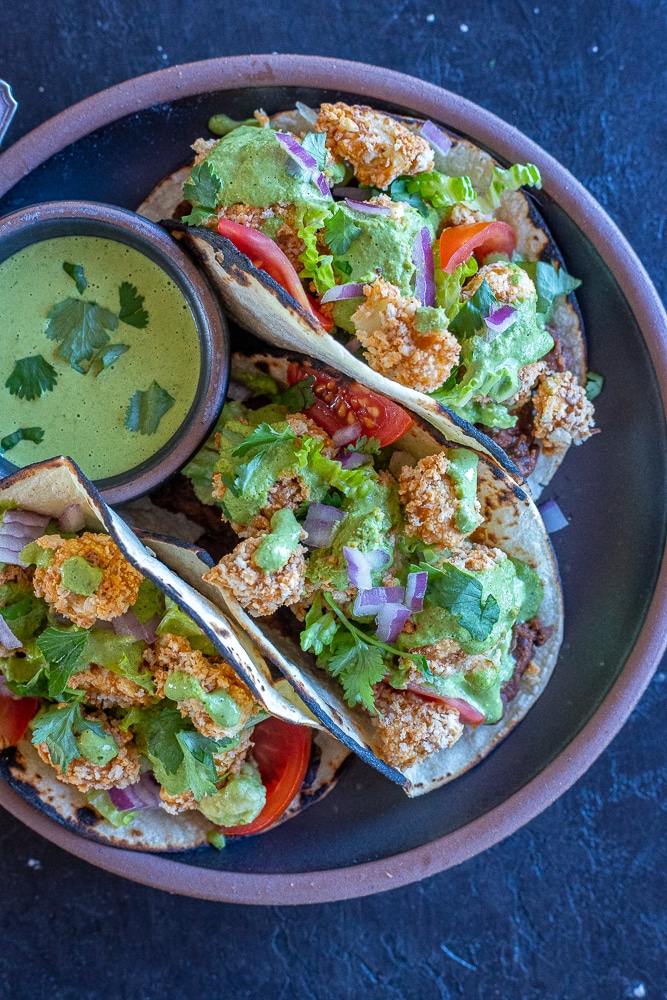 crispy cauliflower tacos with green tahini sauce recipe on a plate