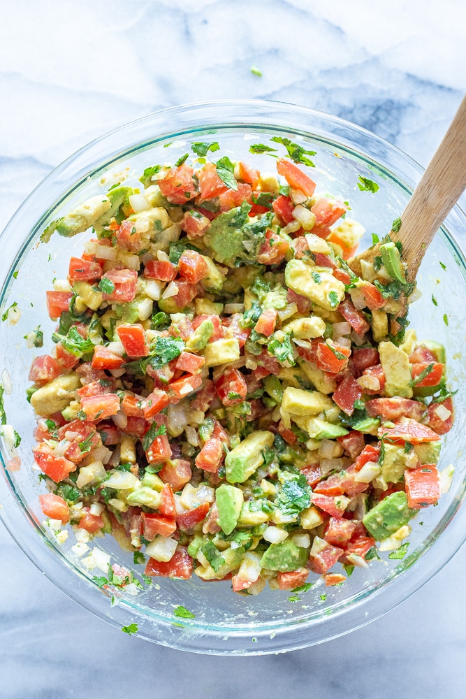 chunky avocado salsa in a bowl mixed up