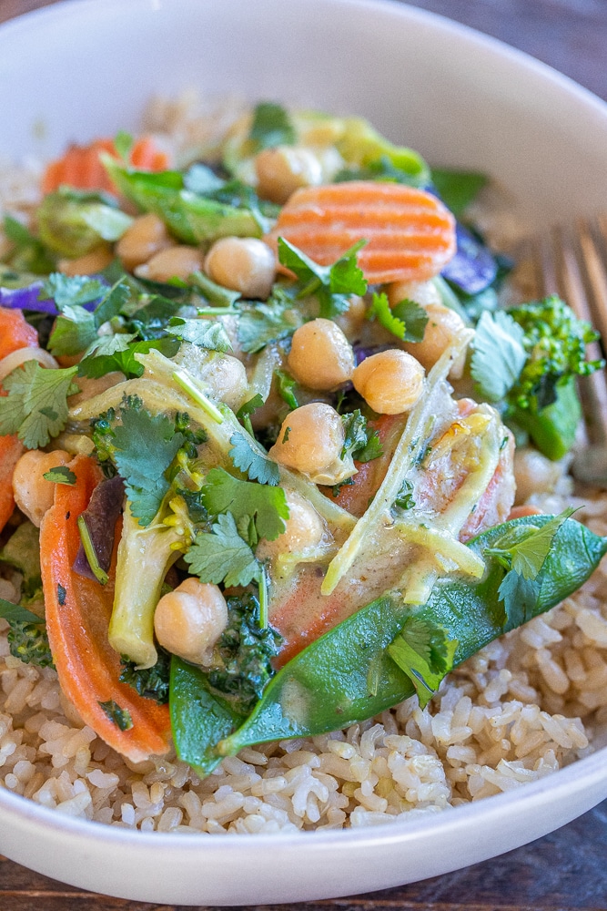 close up of Thai Green Curry Vegetables in a bowl with brown rice