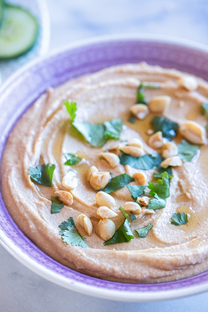 close up of a bowl of peanut butter hummus