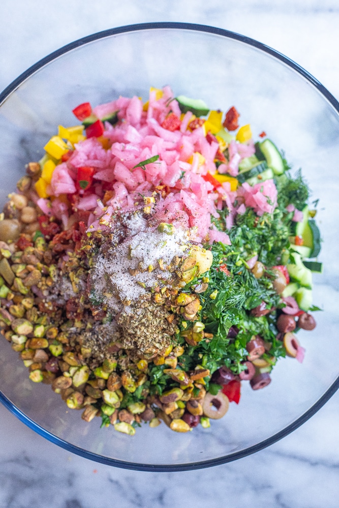all the Mediterranean quinoa salad ingredients in a bowl together
