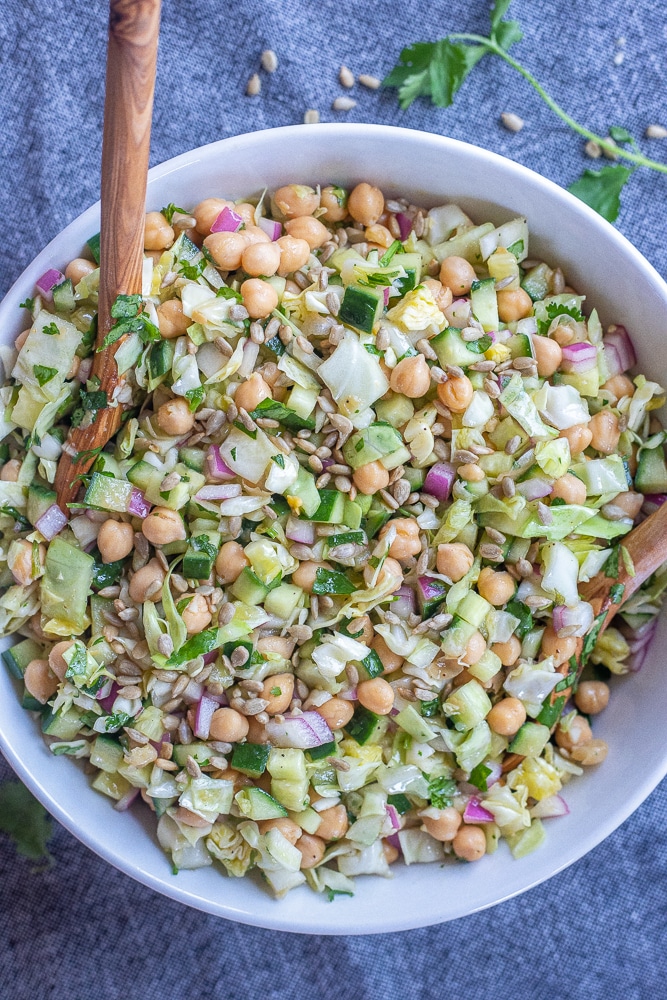 a big bowl of chickpea salad with cucumber and cabbage