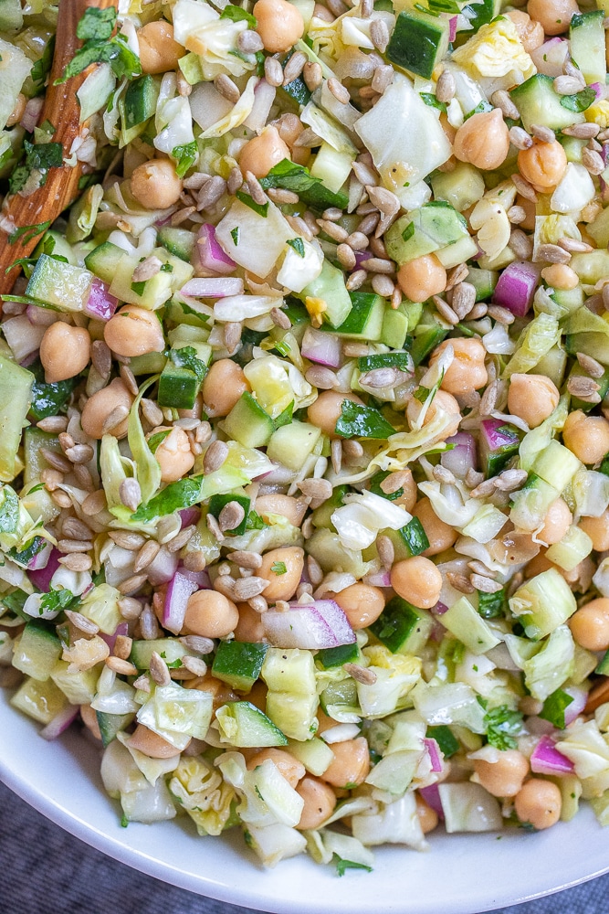close up of chopped chickpea salad with cucumber and cabbage