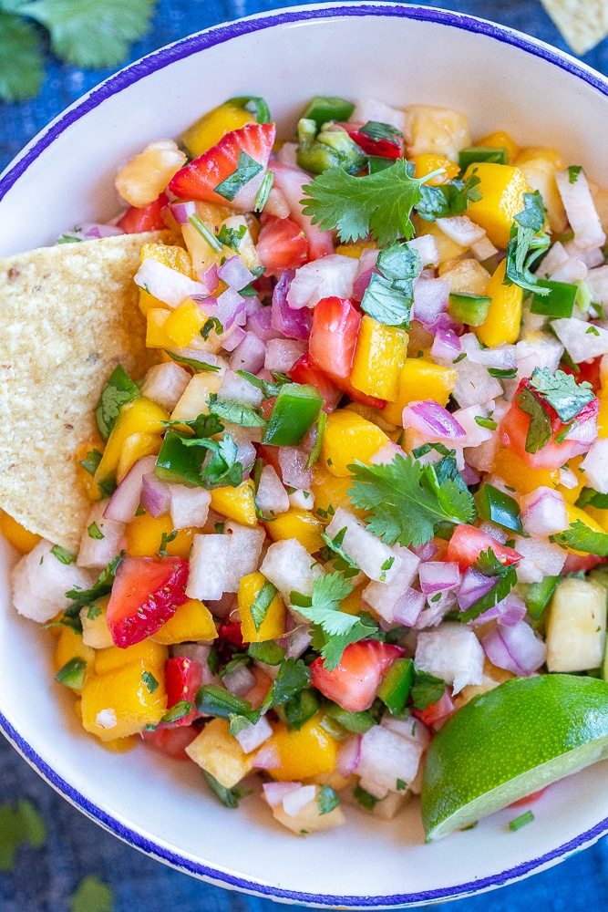 close up of fruit salsa in a bowl with chips
