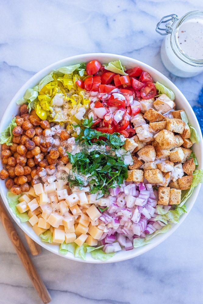 grinder salad with dressing poured over it