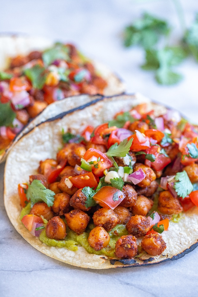 close up of easy chickpea tacos with guacamole and pico de gallo