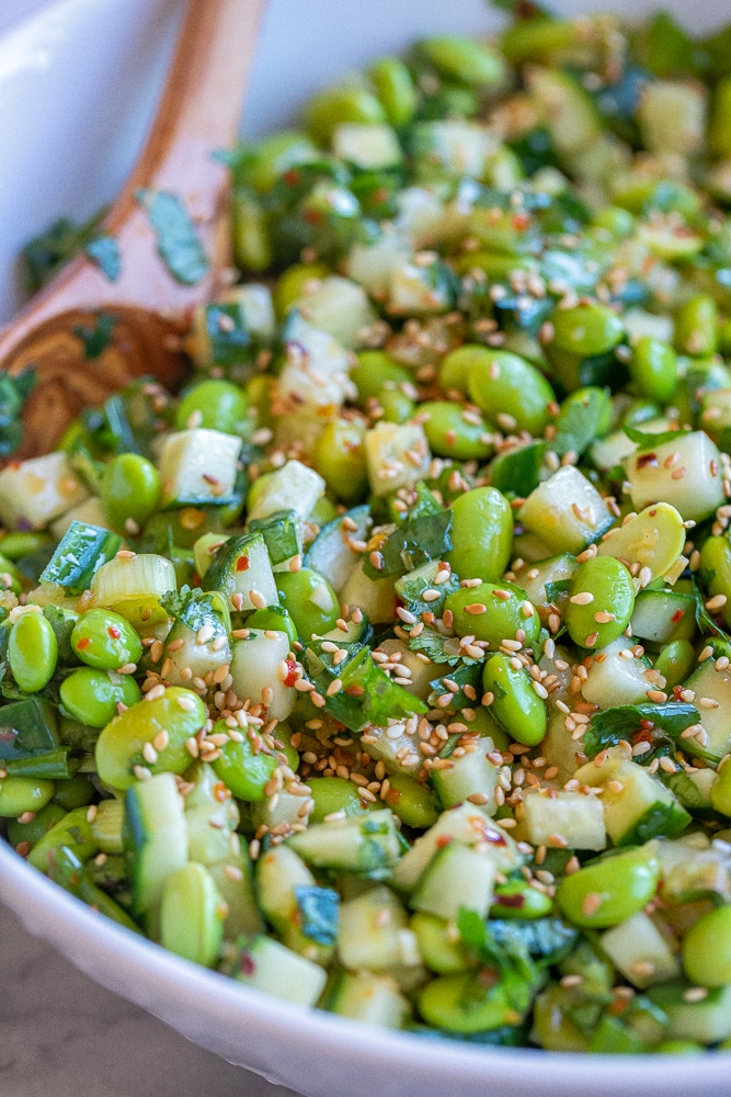 Close up of cucumber edamame salad with toasted sesame seeds on top