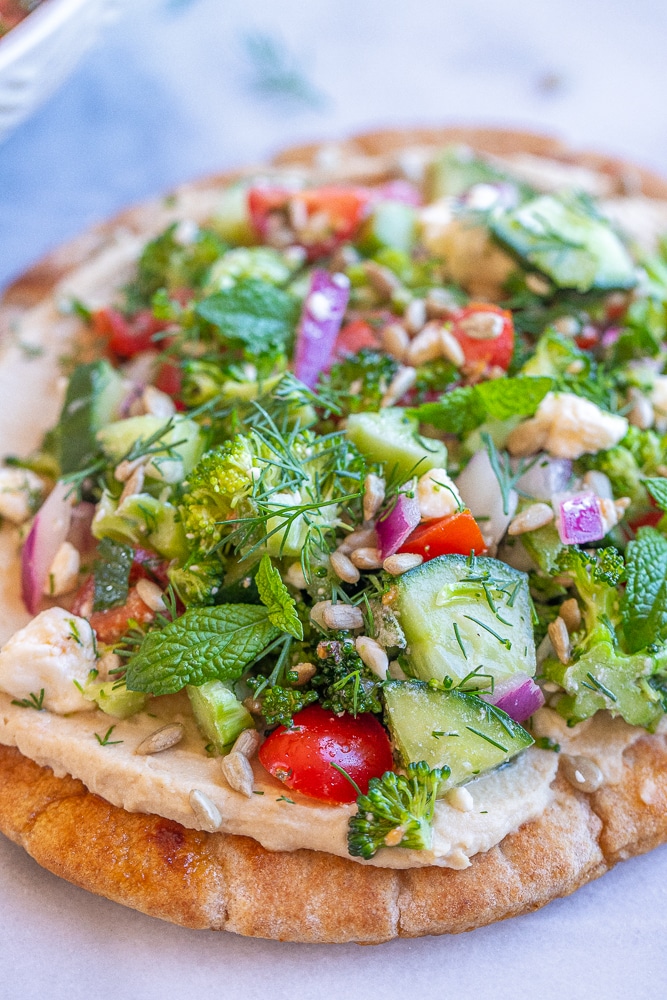 close up of broccoli salad hummus pitas