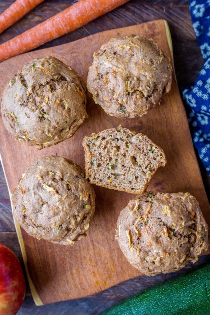 zucchini apple carrot muffins on a cutting board