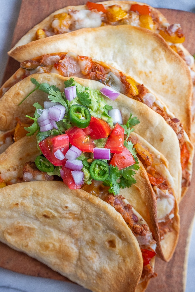 close up of these baked vegetarian tacos on a cutting board