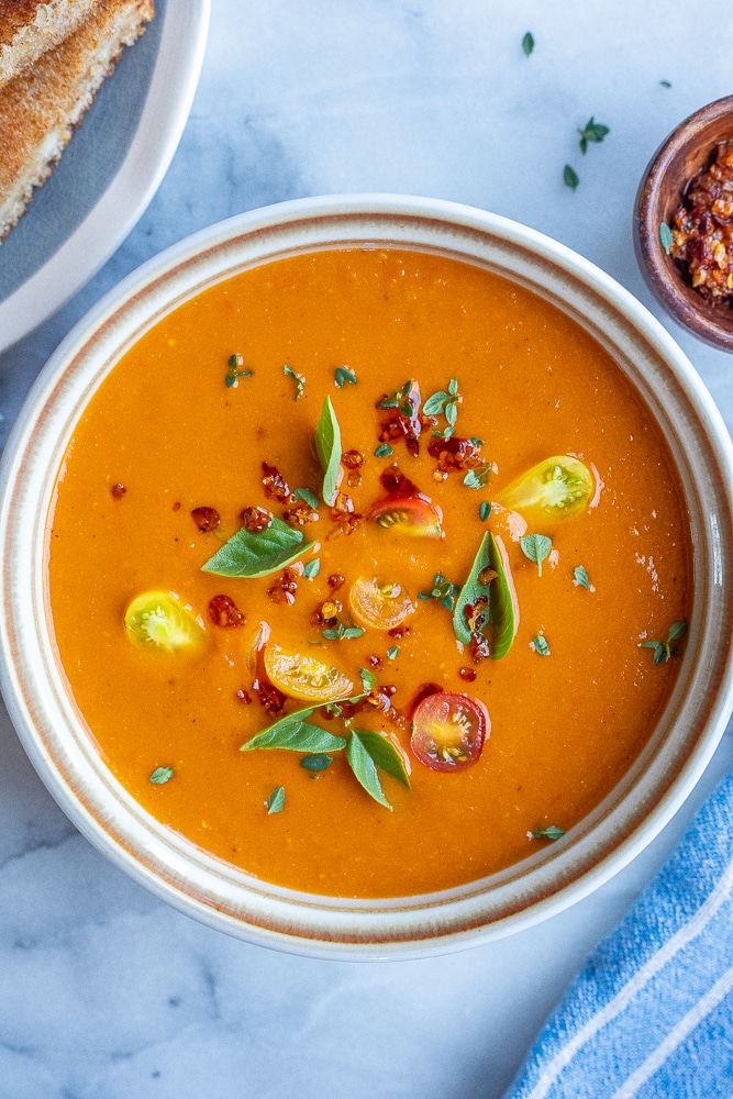 easy sheet pan tomato soup in a bowl with toppings