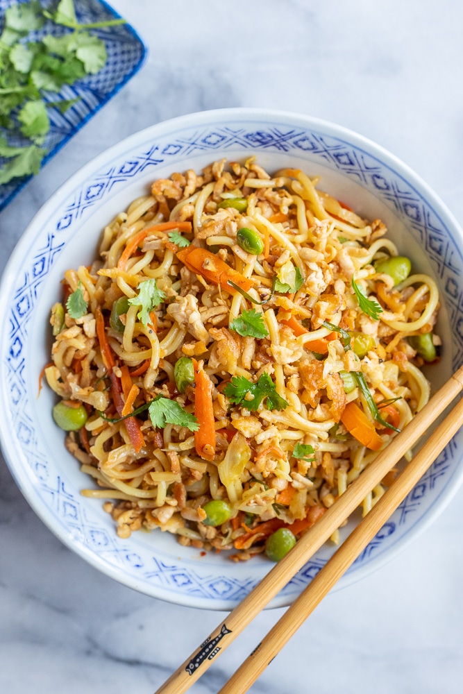 a big bowl of stir fry noodles with crispy tofu