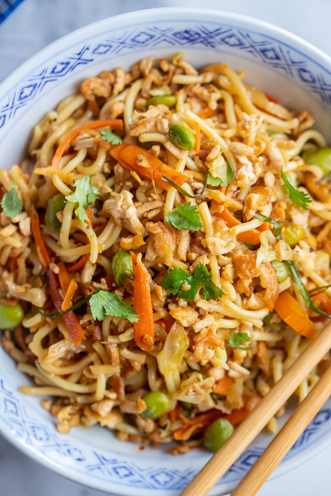 close up of a bowl of stir fry noodles with vegetables