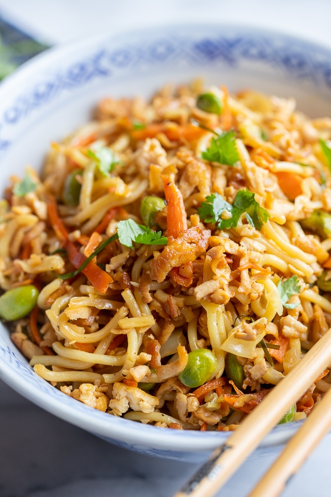 close up of crispy grated tofu with stir fry noodles in a bowl