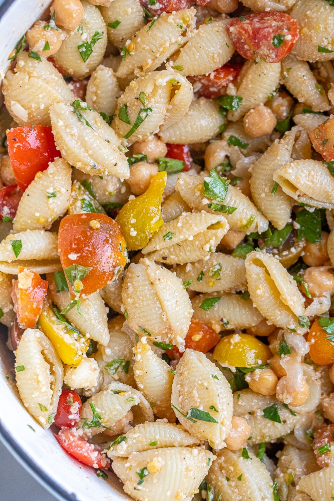 close up of herby parmesan tomato pasta salad in a pot