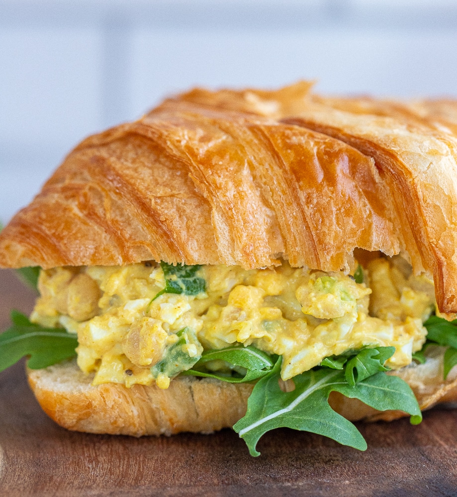 close up of a curried egg salad sandwich with chickpeas