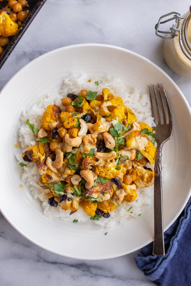 bowl of golden roasted cauliflower with tahini dressing