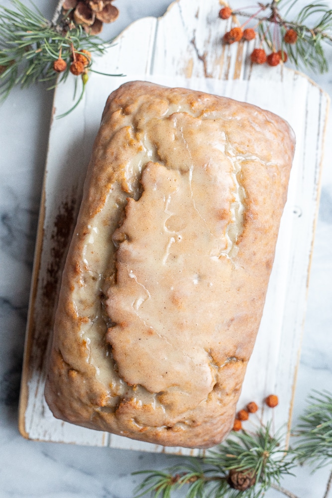 Glazed eggnog banana bread on a cutting board