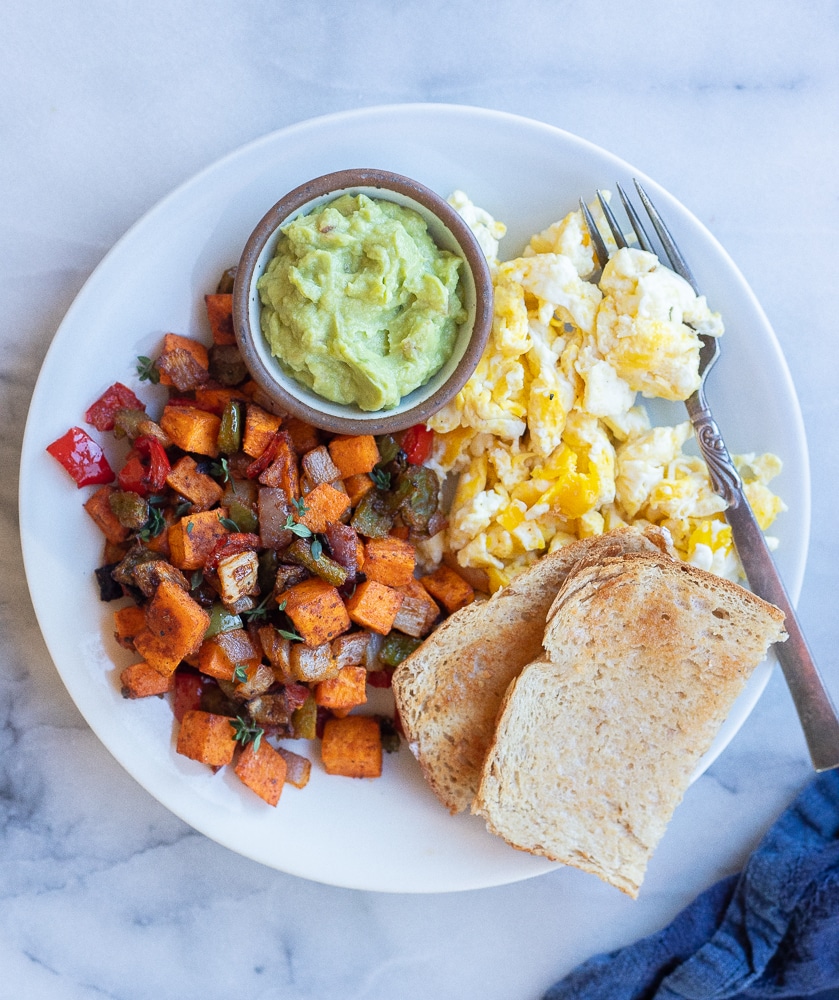 sweet potato hash on a breakfast plate with eggs and toast