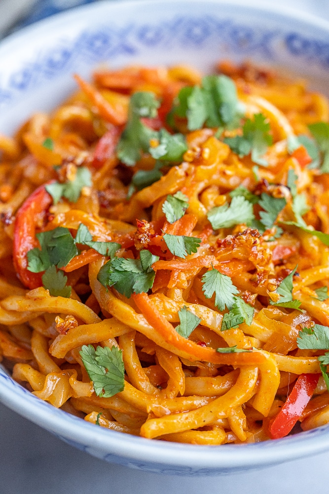 close up of Thai red curry coconut noodles in a bowl