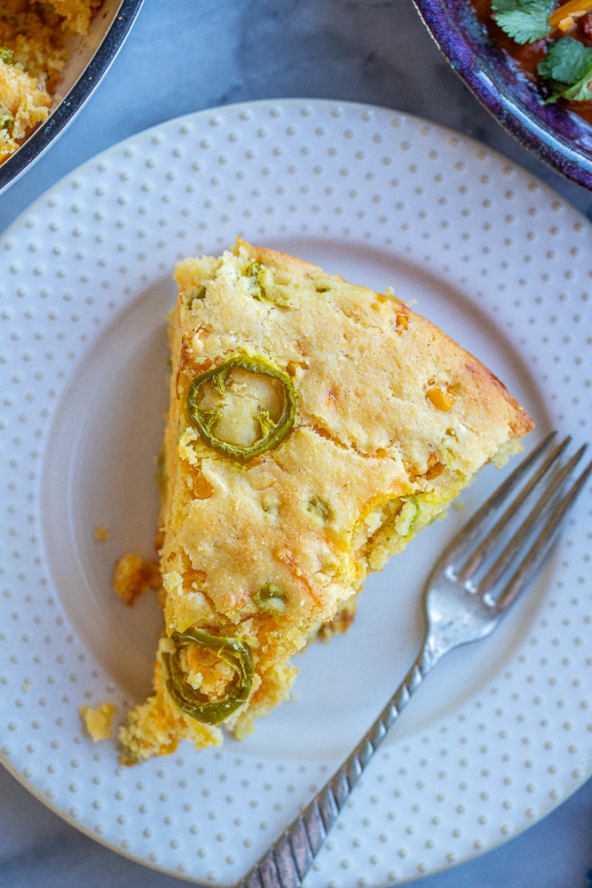 large slice of pickled jalapeño cheddar cornbread on a plate