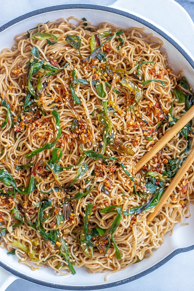 soy scallion noodles in a pan with toppings