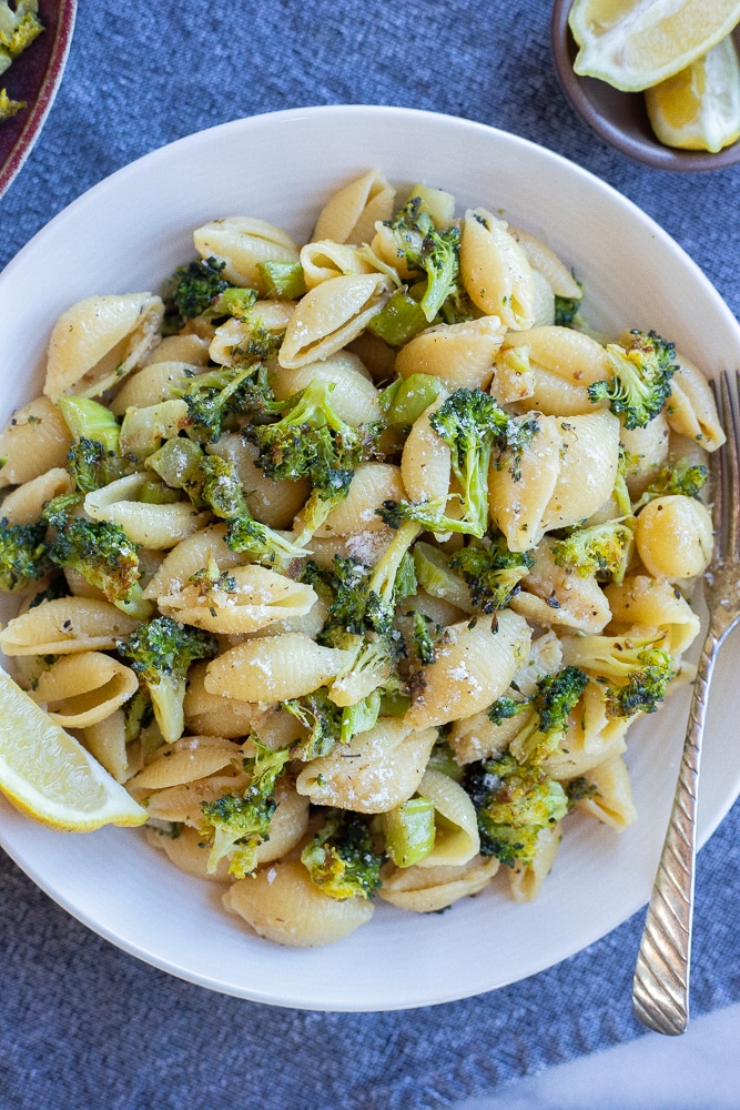 large bowl of garlic parmesan pasta with roasted broccoli with a fork
